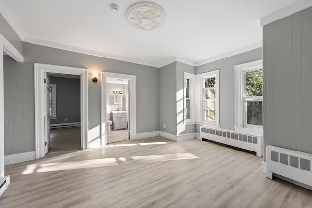 122 Oak St, Naugatuck, CT 06770 - unfurnished bedroom featuring radiator, wood finished floors, crown molding, and a baseboard radiator