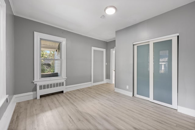 122 Oak St, Naugatuck, CT 06770 - empty room featuring radiator heating unit, wood finished floors, and crown molding