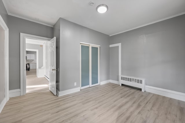 122 Oak St, Naugatuck, CT 06770 - unfurnished room with radiator heating unit, light wood finished floors, crown molding, and a smoke detector
