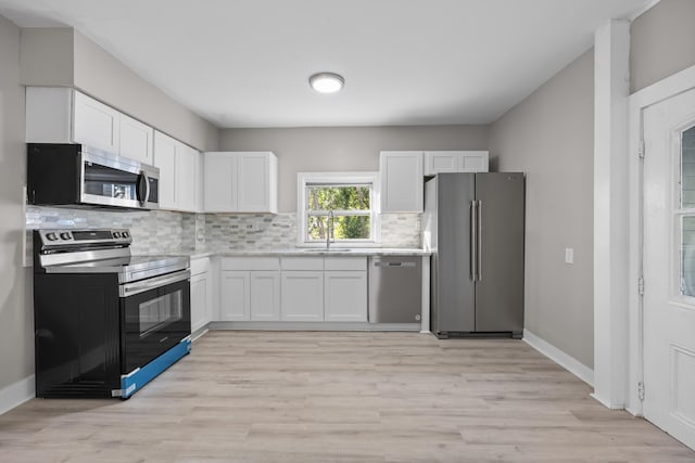 122 Oak St, Naugatuck, CT 06770 - kitchen featuring stainless steel appliances, light countertops, white cabinetry, and tasteful backsplash