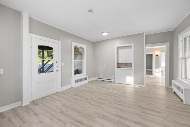 122 Oak St, Naugatuck, CT 06770 - entryway with radiator, light wood-style flooring, and baseboard heating