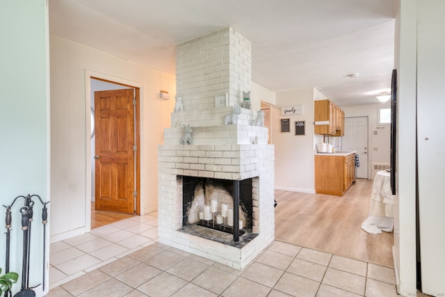 55 Taylor Rd, East Hartford, CT 06110 - living room with light tile patterned flooring and a brick fireplace