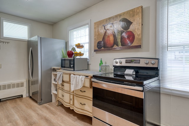 55 Taylor Rd, East Hartford, CT 06110 - kitchen with stainless steel appliances, radiator heating unit, and light wood-type flooring
