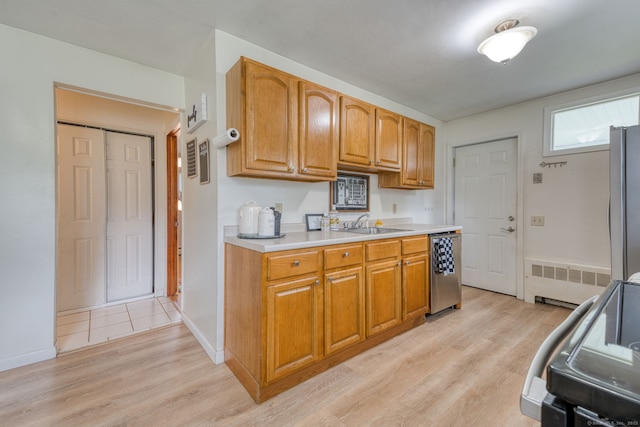 55 Taylor Rd, East Hartford, CT 06110 - kitchen featuring stainless steel appliances, radiator, light wood finished floors, and light countertops