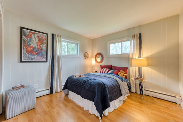 55 Taylor Rd, East Hartford, CT 06110 - bedroom featuring a baseboard radiator, light wood-type flooring, and a decorative wall