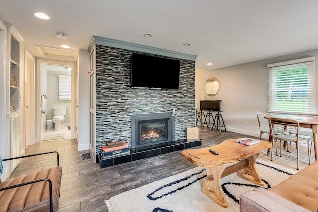 114 Lakeside Dr, East Haddam, CT 06423 - living room with wood finished floors, recessed lighting, a fireplace, and built in shelves