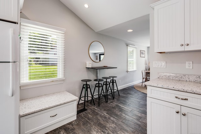 114 Lakeside Dr, East Haddam, CT 06423 - kitchen with freestanding refrigerator, dark wood-style floors, recessed lighting, lofted ceiling, and white cabinets