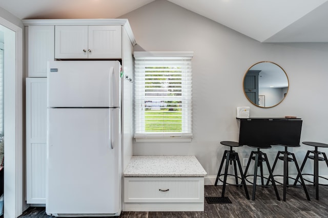 114 Lakeside Dr, East Haddam, CT 06423 - kitchen featuring freestanding refrigerator, dark wood finished floors, white cabinets, vaulted ceiling, and light stone countertops