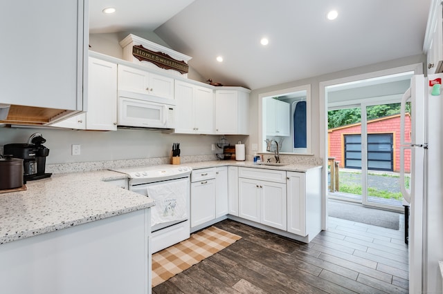 114 Lakeside Dr, East Haddam, CT 06423 - kitchen with white appliances, lofted ceiling, dark wood finished floors, white cabinets, and light stone countertops