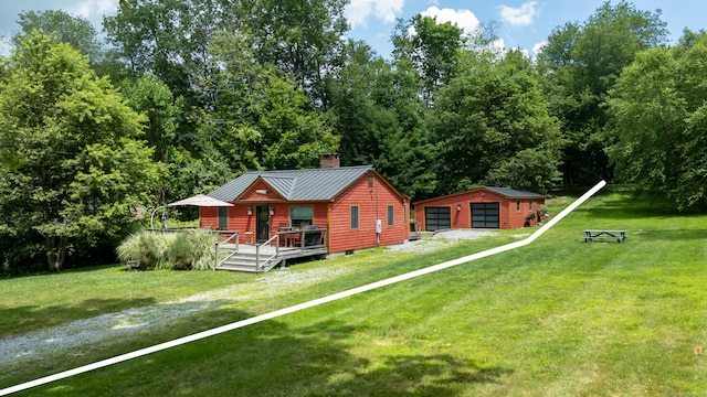 114 Lakeside Dr, East Haddam, CT 06423 - view of front of house with an outbuilding, a detached garage, a chimney, a deck, and a front lawn