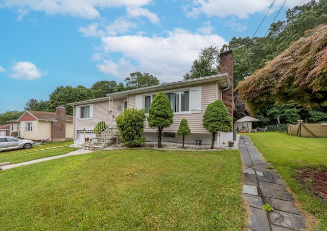 87 Kaynor Dr, Waterbury, CT 06708 - split foyer home with a front yard, a chimney, and an attached garage