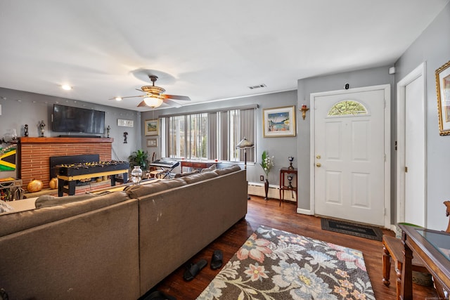 87 Kaynor Dr, Waterbury, CT 06708 - living area featuring plenty of natural light, a brick fireplace, a ceiling fan, and dark wood-type flooring