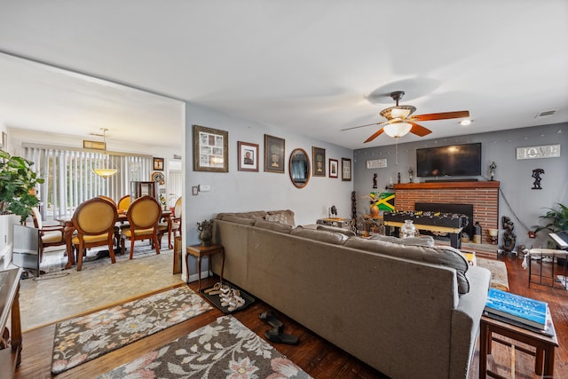 87 Kaynor Dr, Waterbury, CT 06708 - living area with ceiling fan, wood finished floors, and a brick fireplace