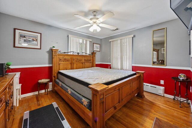 87 Kaynor Dr, Waterbury, CT 06708 - bedroom featuring a baseboard heating unit, wood finished floors, and a ceiling fan