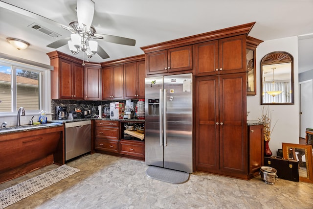 87 Kaynor Dr, Waterbury, CT 06708 - kitchen with stainless steel appliances, tasteful backsplash, a ceiling fan, and dark stone countertops