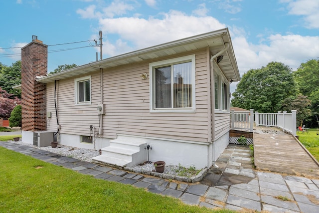 87 Kaynor Dr, Waterbury, CT 06708 - view of home's exterior featuring a wooden deck and a chimney