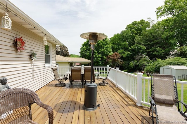 87 Kaynor Dr, Waterbury, CT 06708 - wooden deck with outdoor dining space and a storage unit