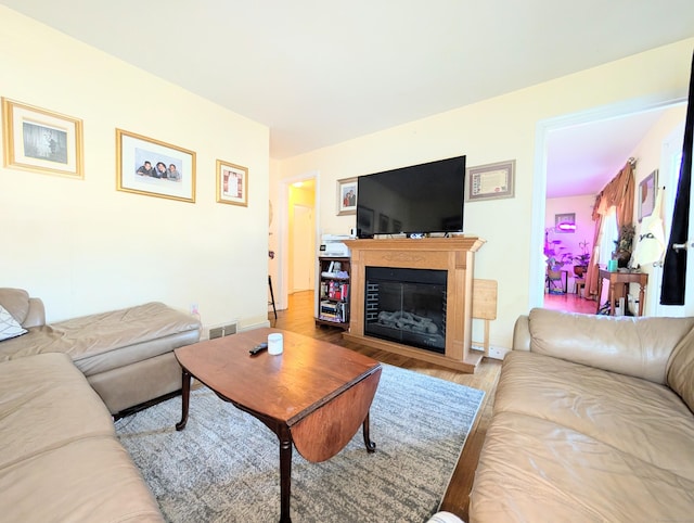 943 Success Ave, Stratford, CT 06614 - living area with wood finished floors and a glass covered fireplace