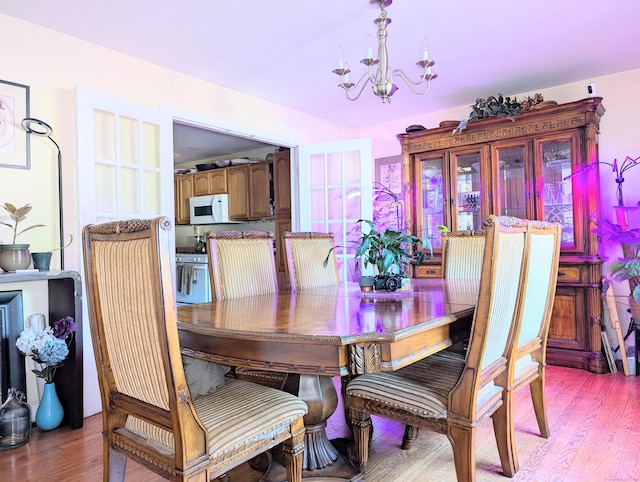 943 Success Ave, Stratford, CT 06614 - dining room featuring a chandelier and light wood-style flooring