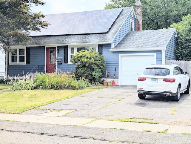 943 Success Ave, Stratford, CT 06614 - view of front of house with a garage, asphalt driveway, solar panels, roof with shingles, and a chimney