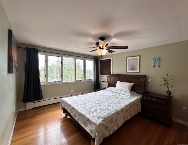 2 Wentworth Dr, Milford, CT 06460 - bedroom featuring a baseboard heating unit, dark wood-style flooring, and a ceiling fan