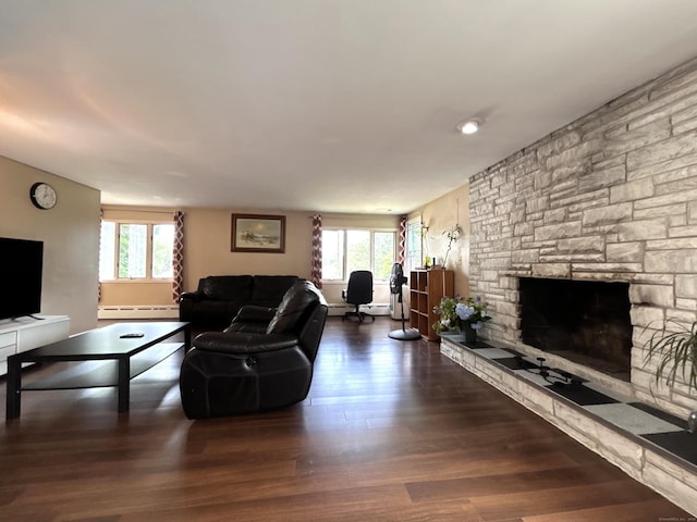 2 Wentworth Dr, Milford, CT 06460 - living area with a baseboard heating unit, plenty of natural light, wood finished floors, and a stone fireplace