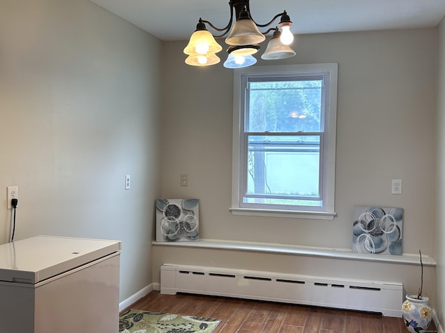 2 Wentworth Dr, Milford, CT 06460 - laundry area featuring baseboard heating, a chandelier, and wood finished floors