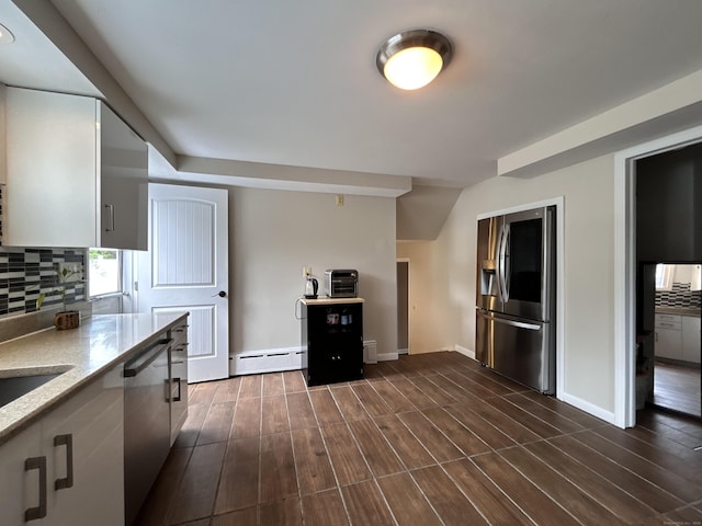 2 Wentworth Dr, Milford, CT 06460 - kitchen with stainless steel appliances, a baseboard heating unit, decorative backsplash, dark wood-style floors, and light stone counters