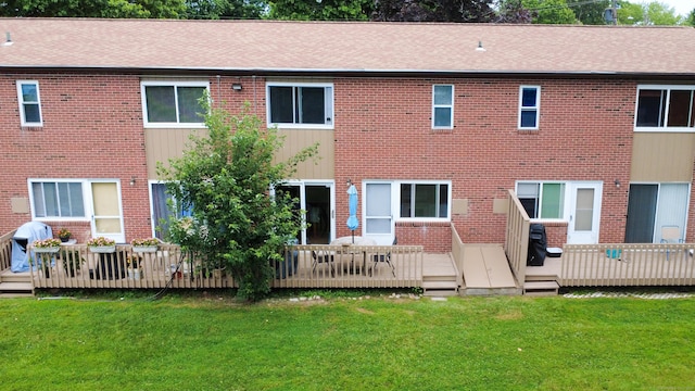 275 Pierremount Ave Unit 275, New Britain, CT 06053 - back of property with brick siding, a lawn, and a deck