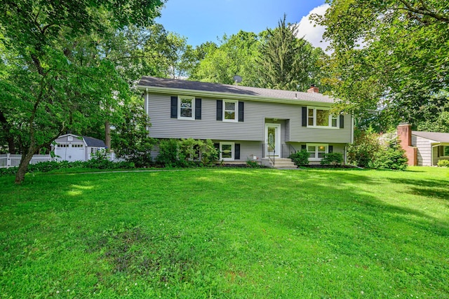 15 Sky Edge Ln, Bethel, CT 06801 - bi-level home featuring a chimney, a front lawn, and an outdoor structure
