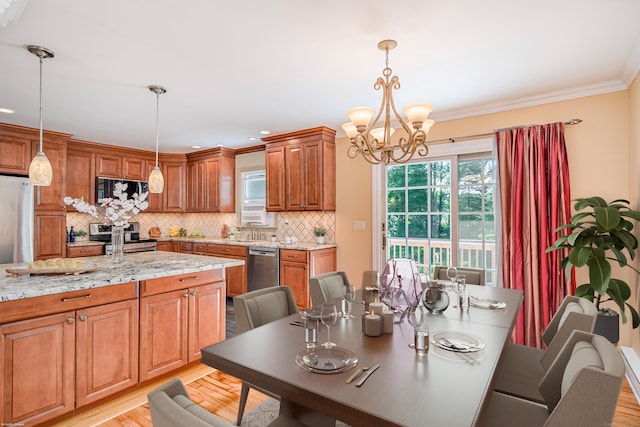 15 Sky Edge Ln, Bethel, CT 06801 - kitchen with appliances with stainless steel finishes, a chandelier, decorative backsplash, light stone countertops, and brown cabinets