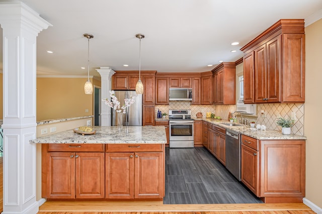 15 Sky Edge Ln, Bethel, CT 06801 - kitchen with appliances with stainless steel finishes, decorative columns, brown cabinets, tasteful backsplash, and light stone counters