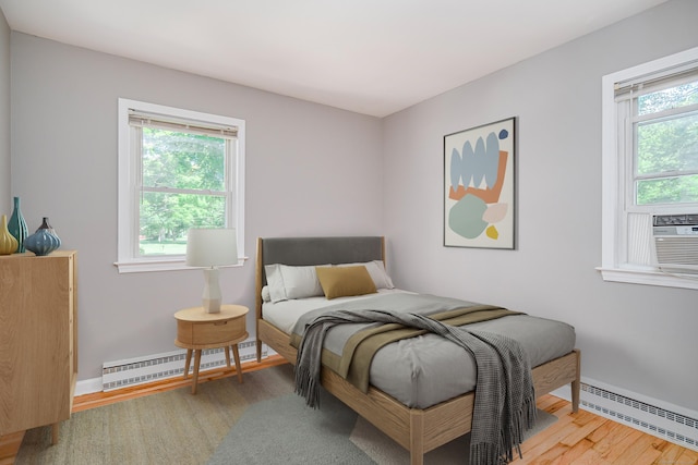 15 Sky Edge Ln, Bethel, CT 06801 - bedroom featuring a baseboard heating unit and wood finished floors