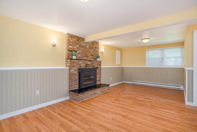 15 Sky Edge Ln, Bethel, CT 06801 - unfurnished living room featuring a baseboard radiator, wood finished floors, wainscoting, and a brick fireplace
