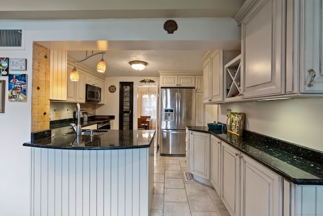 35 Grandview Ter, Wethersfield, CT 06109 - kitchen featuring appliances with stainless steel finishes, a peninsula, tasteful backsplash, open shelves, and dark stone counters
