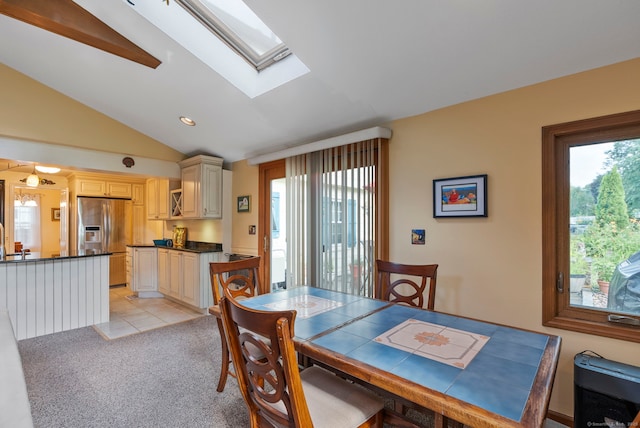 35 Grandview Ter, Wethersfield, CT 06109 - dining space with vaulted ceiling, a skylight, light carpet, and light tile patterned floors