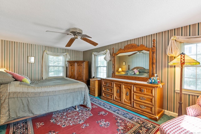 35 Grandview Ter, Wethersfield, CT 06109 - carpeted bedroom featuring multiple windows, a textured ceiling, wallpapered walls, and a ceiling fan