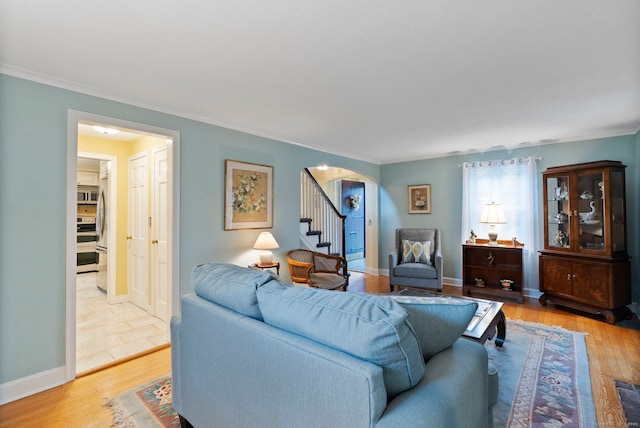 35 Grandview Ter, Wethersfield, CT 06109 - living area featuring arched walkways, stairs, crown molding, and light wood finished floors