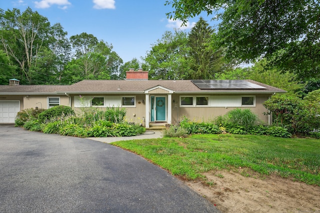 3 Laurel Hill Dr S, East Lyme, CT 06357 - single story home featuring a chimney, roof mounted solar panels, an attached garage, a front yard, and asphalt driveway