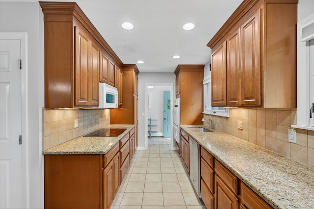 3 Laurel Hill Dr S, East Lyme, CT 06357 - kitchen with white microwave, recessed lighting, brown cabinetry, stainless steel dishwasher, and black electric stovetop