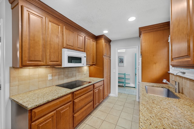 3 Laurel Hill Dr S, East Lyme, CT 06357 - kitchen featuring white microwave, black electric cooktop, light tile patterned floors, light stone countertops, and backsplash