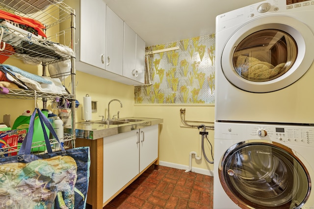 3 Laurel Hill Dr S, East Lyme, CT 06357 - laundry room with stacked washing machine and dryer, brick patterned floors, and cabinet space