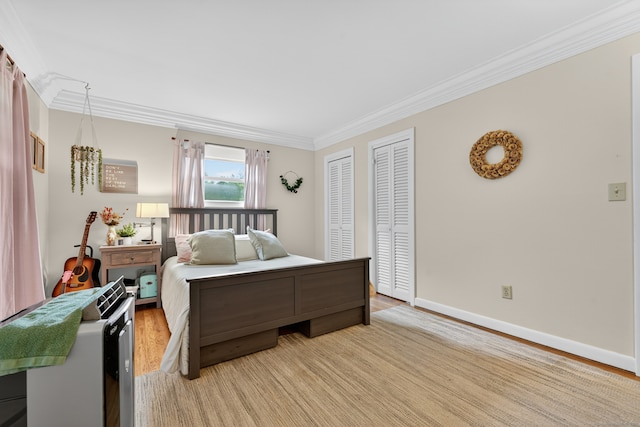 3 Laurel Hill Dr S, East Lyme, CT 06357 - bedroom featuring crown molding, two closets, and light wood-style flooring