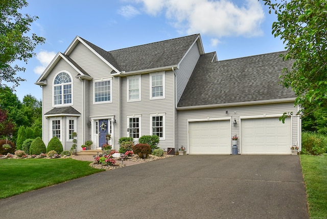 55 Hydrangea Ln, Suffield, CT 06078 - colonial-style house featuring a garage, roof with shingles, driveway, and a front lawn