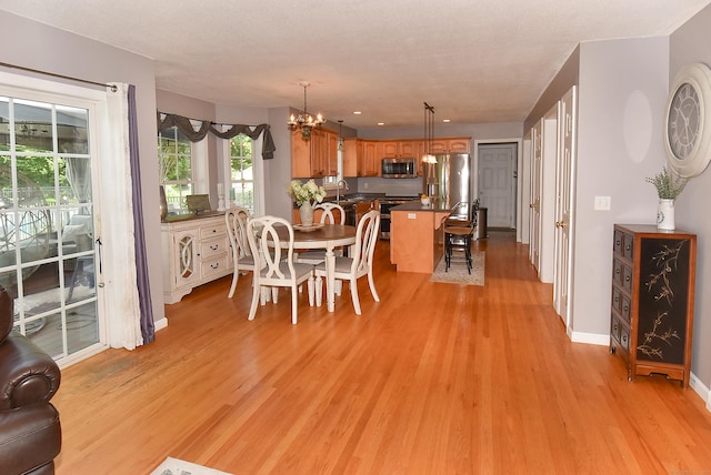 55 Hydrangea Ln, Suffield, CT 06078 - dining space featuring light wood-style floors and a chandelier