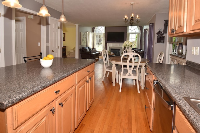55 Hydrangea Ln, Suffield, CT 06078 - kitchen featuring a fireplace, light wood-type flooring, ornate columns, and pendant lighting