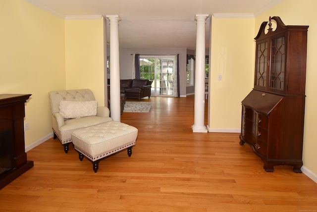55 Hydrangea Ln, Suffield, CT 06078 - sitting room featuring ornate columns, light wood-style flooring, and ornamental molding