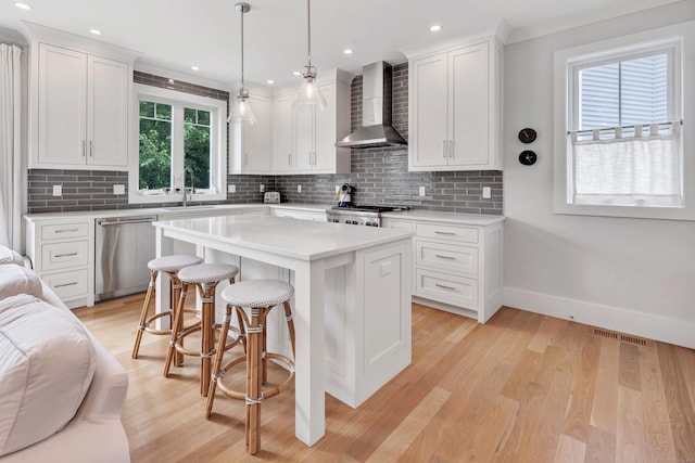 888 Oldfield Rd, Fairfield, CT 06824 - kitchen featuring wall chimney range hood, dishwasher, a kitchen bar, white cabinetry, and backsplash