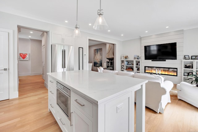 888 Oldfield Rd, Fairfield, CT 06824 - kitchen with appliances with stainless steel finishes, light wood-style flooring, a center island, recessed lighting, and white cabinetry