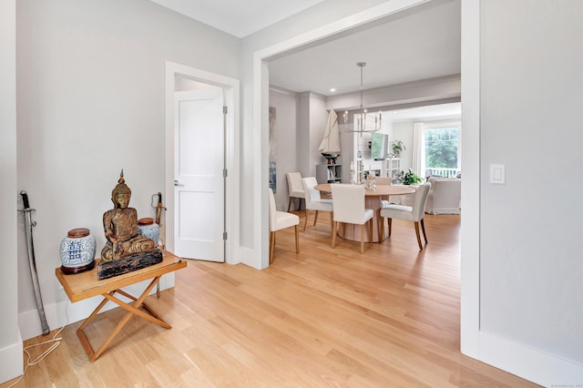 888 Oldfield Rd, Fairfield, CT 06824 - dining area featuring light wood-style floors, a chandelier, and ornamental molding